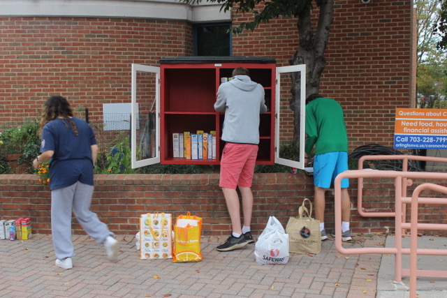 people filling the little free pantry