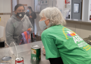 afac volunteer distributing food to client